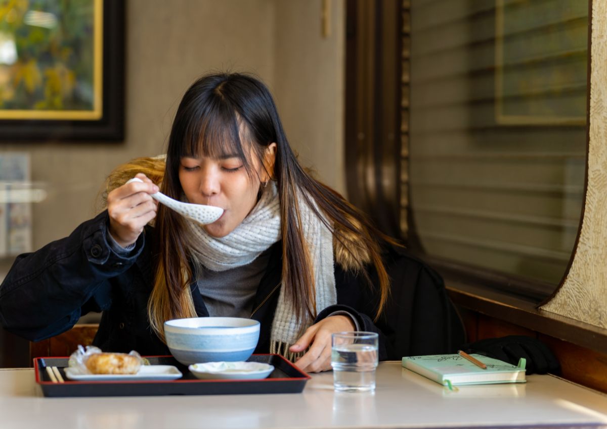 Donna che cena in un ristorante giapponese in inverno