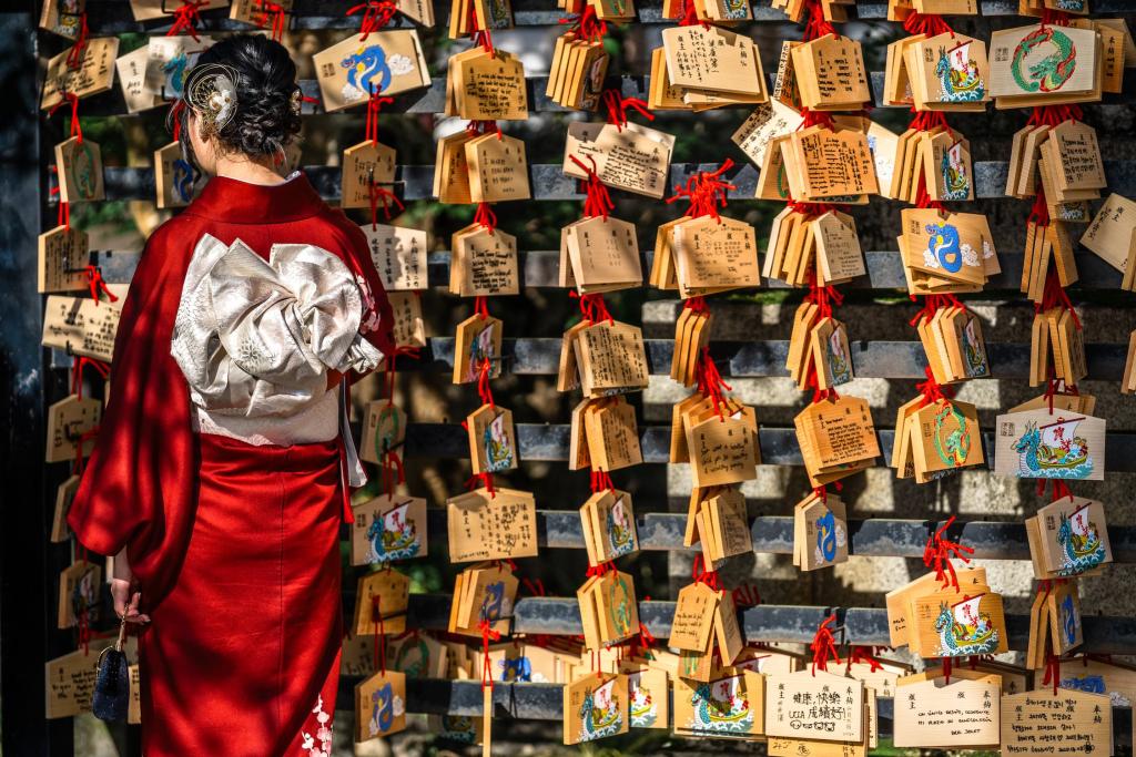 Donna giapponese legge i biglietti di preghiera su una tavola di legno nel tempio di Kiyomizu-dera a Kyoto